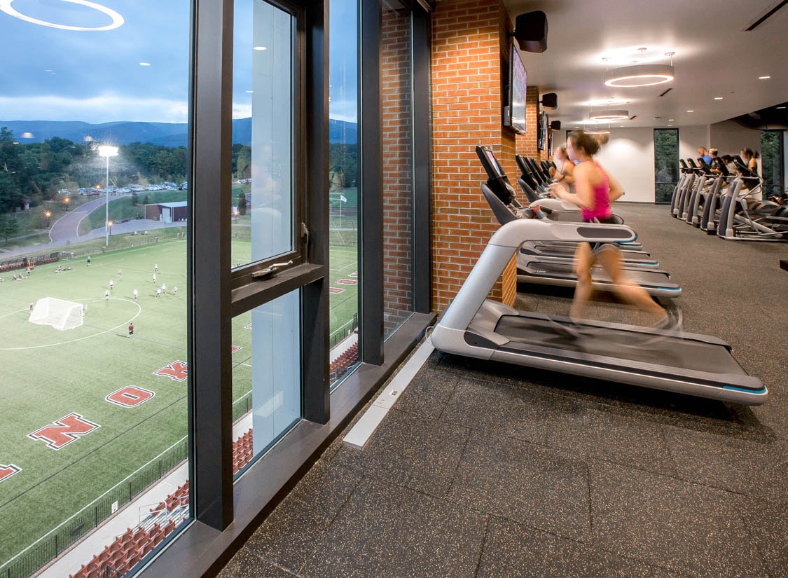 The Cregger Center houses three main volumes: a 2,500-seat basketball arena and performance gym (with 12 locker rooms), a field house with a 200-meter indoor track, and a fitness center open to the community and overlooking Kerr Stadium and the Blue Ridge Mountains.